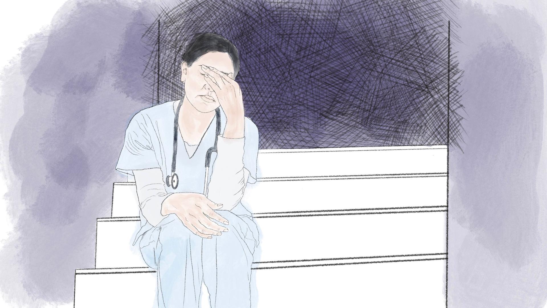 Eine Krankenpflegerin sitzt in der Ecke und ist einfach nur müde.